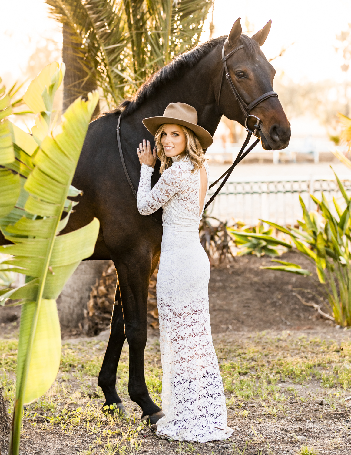 girl in lace dress with bay horse